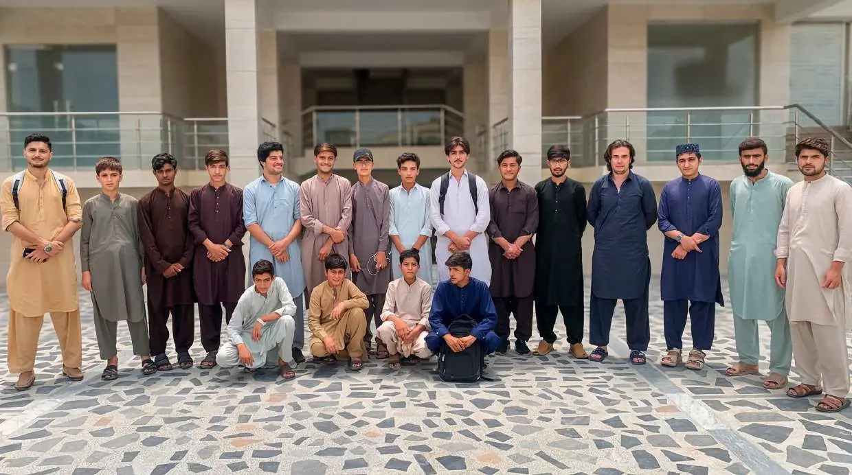 Large group of KISI students posing for a batch photograph in the campus courtyard