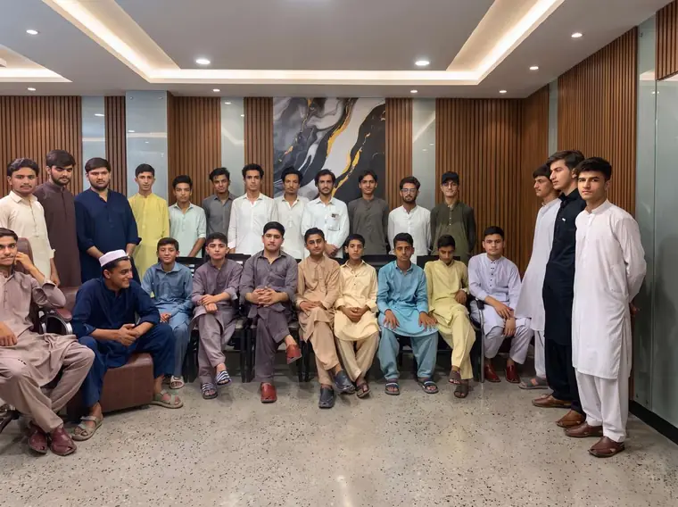 Group of KISI trainees seated and standing for a photograph inside the institute conference hall