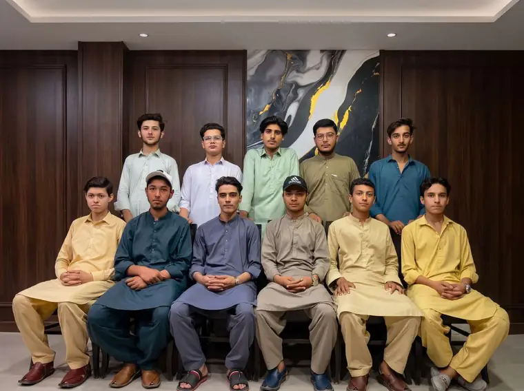 Smaller KISI batch seated for a formal portrait in the wood panelled boardroom